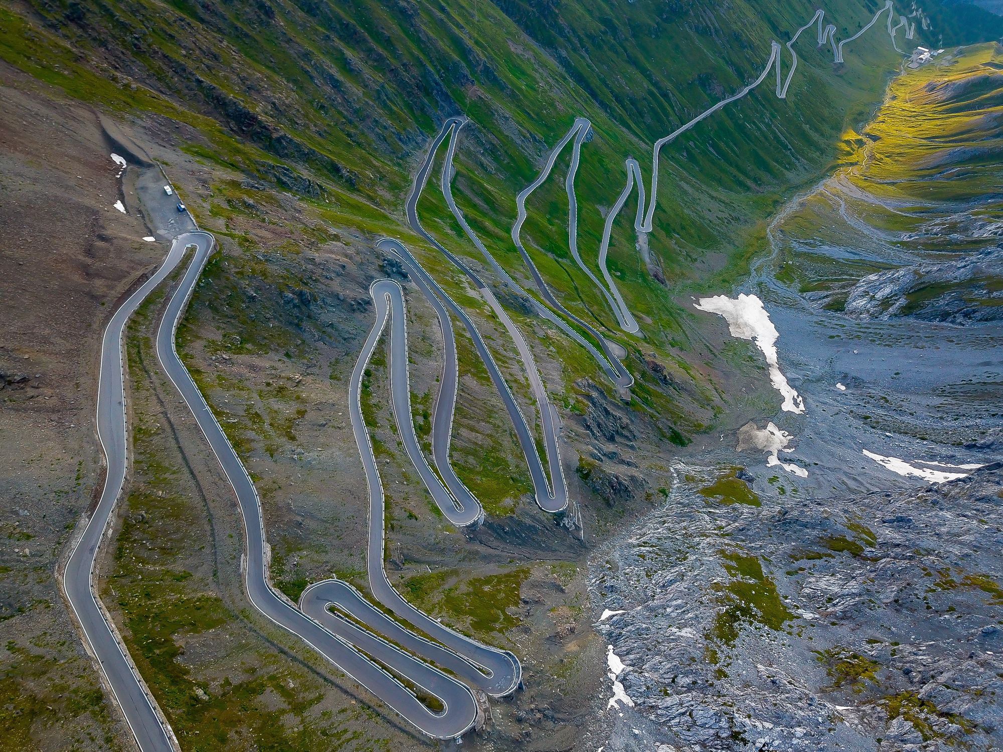 Aerial view of the Stelvio Pass switchbacks winding across the mountainside