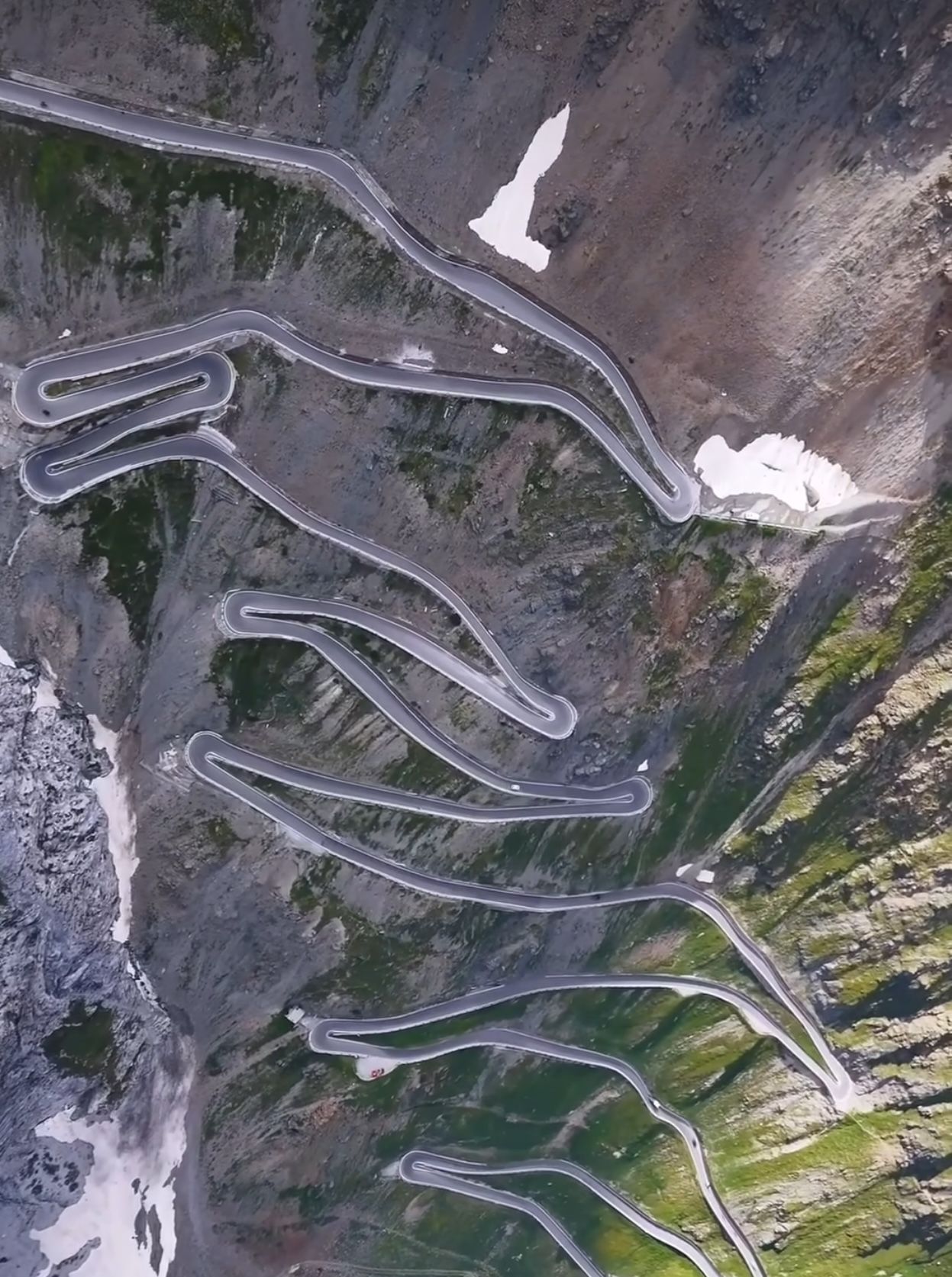 Switchbacks climbing an alpine pass, seen from directly above
